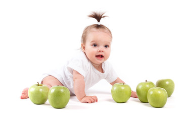 Fototapeta premium cute cheerful little girl in white shirt near apples