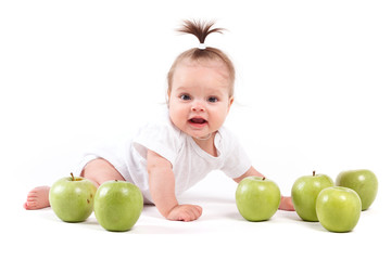 Fototapeta na wymiar cute confusedl little girl in white shirt and with apples