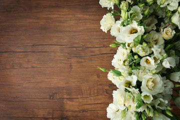 Beautiful eustoma flowers on wooden background
