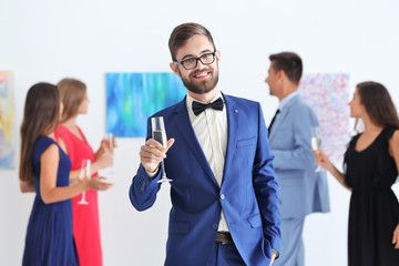 Young man in formal wear at art gallery exhibition