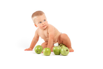 cute boy in diapers with green apples