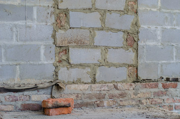 Bricked up door and cinder blocks brick wall texture. Abandoned house exterior.
