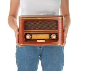 Woman holding radio on white background