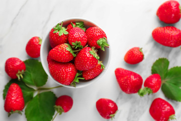 Bowl with fresh strawberries on table