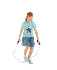 Cute little girl jumping rope on white background