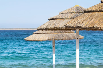 Straw umbrellas on the beach