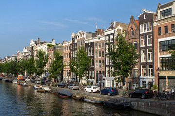 Fototapeta na wymiar Houses and Boats on Amsterdam Canal..