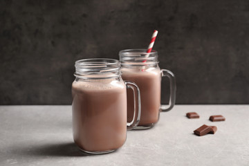 Mason jars with yummy cocoa on table