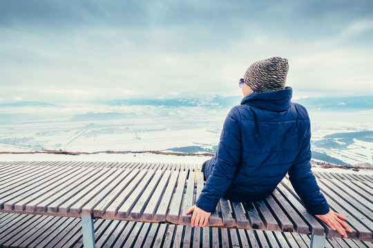 Woman relax on top hill point with beautiful panorame view on winter city