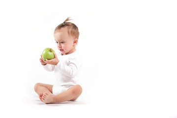 Fototapeta premium cute beauty little girl in white pijamas with apple