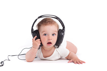 cute happy little boy in white shirt with headphones