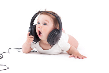 cute happy little boy in white shirt with headphones