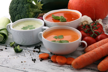 Variety of colorful vegetables cream soups and ingredients for soup. Concept of healthy eating or vegetarian food