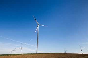 white wind power plants in a field
