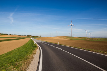 white wind power plants in a field