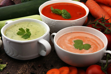 Variety of colorful vegetables cream soups and ingredients for soup. Concept of healthy eating or vegetarian food