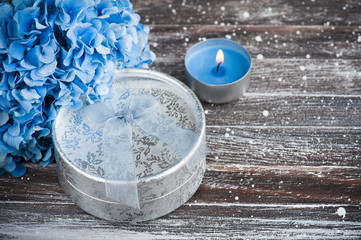 Blue hydrangea bouquet, gift with bow, lit candle