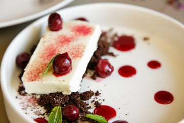 cake with cherries on background
