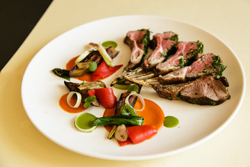 Racks of lamb on plate, isolated over black background