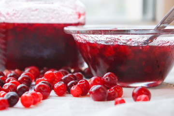 Jam in a bowl, berries and a jar of close-up jam