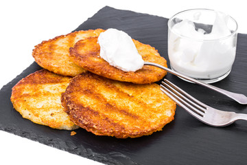 Potato pancakes with white sauce.