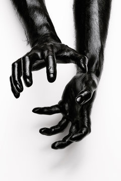 Abstract shot of human hands painted in black