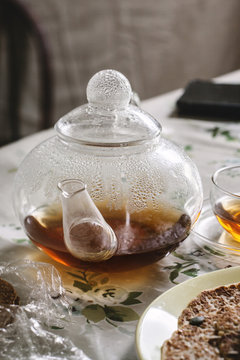 Pot of tea within a breakfast table setting.