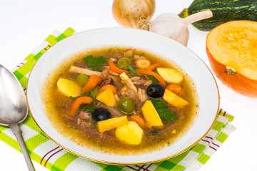 Soup with pumpkin in white plate