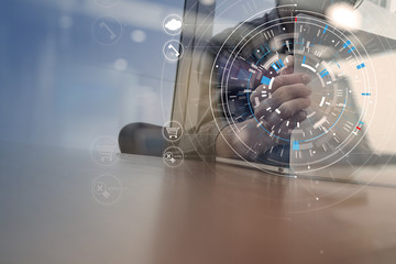 businessman hand working with modern laptop computer in modern office with virtual icon diagram