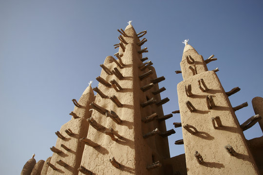 Facade with three minarets of adobe mosque in Teli, Dogon countr