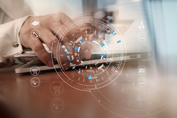 Close up of Hand using credit card and laptop computer on wooden desk with VR icon chart graph diagram