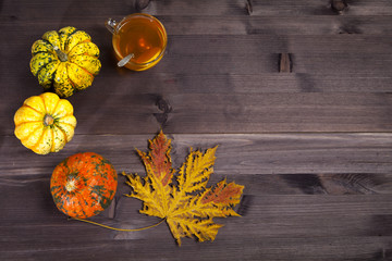 the Autumnal vegetables and leaves on dark wood
