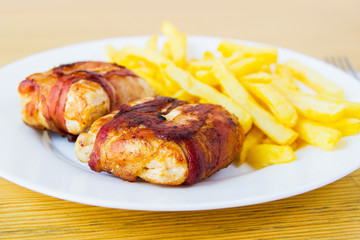 Grilled bacon wrapped chicken breast  with french fries