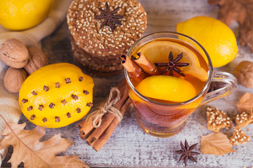 Autumn hot tea with lemon in glass cup.