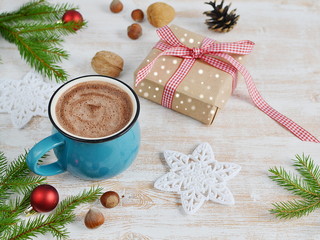 Cup of Chocolate with Marshmallows, Christmas Decorations on Wooden table, Pine Branch, Snow Down, Toned Photo