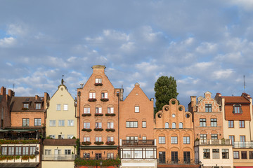 Fototapeta premium View of old buildings along the Long Bridge waterfront at the Main Town in Gdansk, Poland, in the daytime. Copy space.