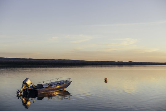 Boat and Buoy Reflection at Sunset