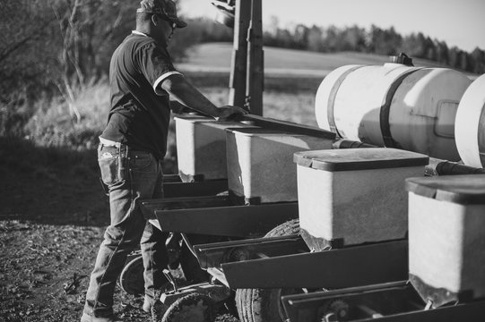 African American Farmer Closing Seed Buckets On His Integral Pla