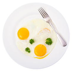 Fried eggs on white plate for breakfast