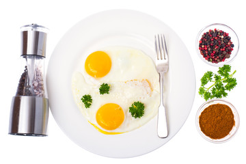 Fried eggs on white plate for breakfast
