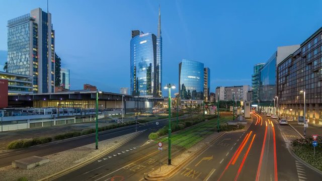 Milan skyline with modern skyscrapers in Porta Nuova business district day to night timelapse in Milan, Italy, after sunset.
