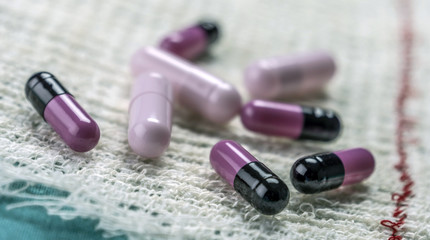 Some pink and black Pills Wrapped In Gauze 