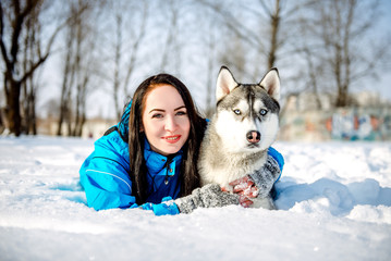 Naklejka na ściany i meble girl with a dog in winter Husky