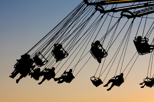 kids in silhouette on wave swinger
