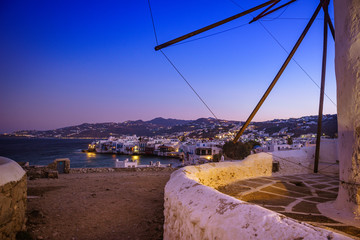 Little Venice, Mykonos island, Greece and windmill on the foreground at sunset