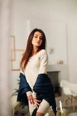 Fototapeta premium A girl with beautiful hair in a room with a festive atmosphere