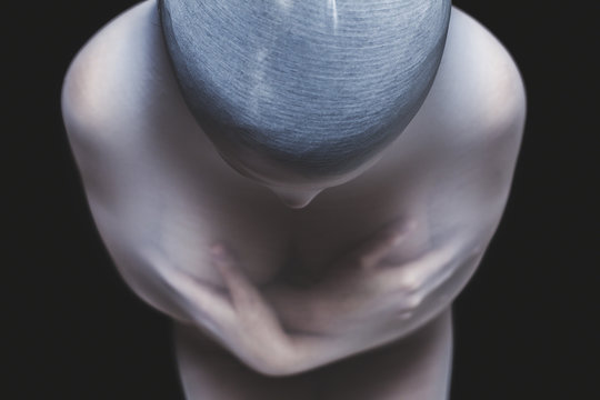 Naked woman in a transparent cocoon from above