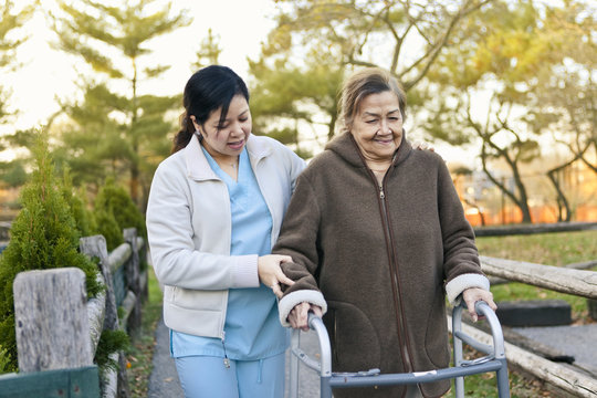 Homecare Nurse Helps Senior Citizen Patient Exercise
