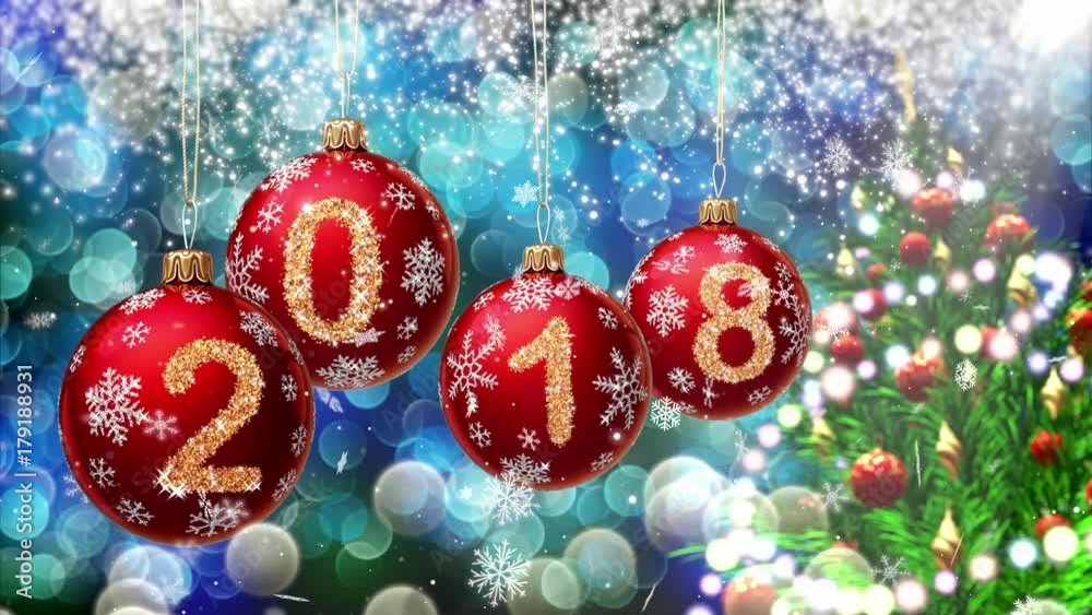 Poster red balls with numbers 2018 hanging on the background of a blue bokeh and a rotating christmas tree 