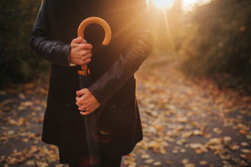 Autumn woman in autumn park with black umbrella
